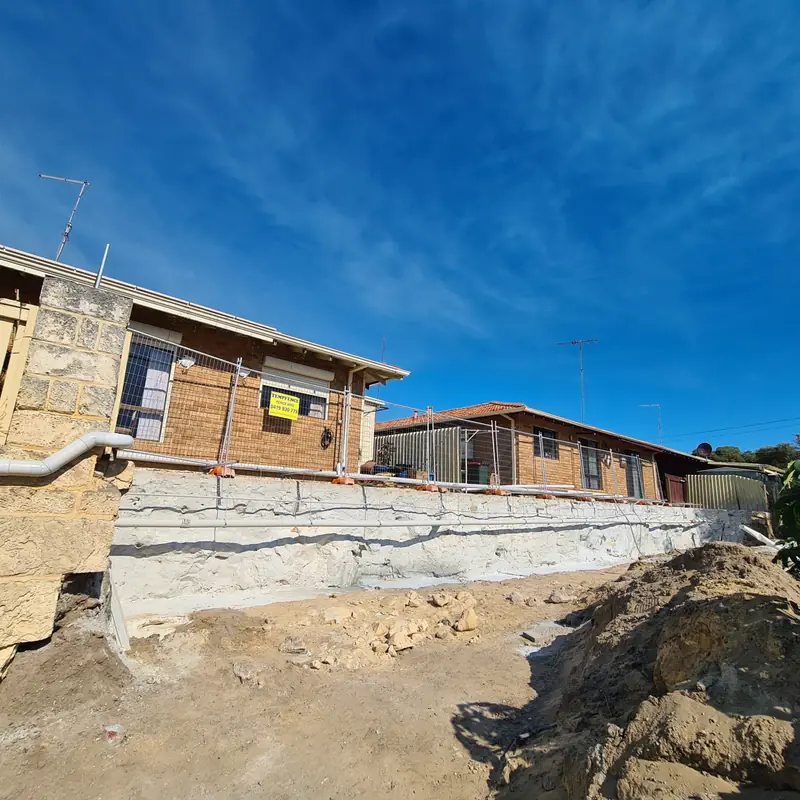 Treated, stabilised ground exposed beneath the footings of an existing brick home